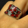 A beautiful ring with enamel and red flowers, size Q.