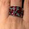 A beautiful ring with enamel and red flowers, size Q.