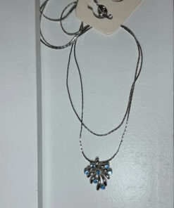 Silver-colored pendant with blue stones on a chain.