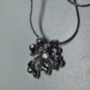 Silver-colored pendant with blue stones on a chain.