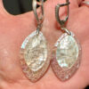 Silver earrings with a mother-of-pearl mosaic, shimmering in pink, white, and blue tones.