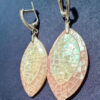 Silver earrings with a mother-of-pearl mosaic, shimmering in pink, white, and blue tones.