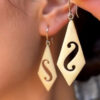 Vintage carved bone dangle earrings in a diamond shape.