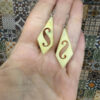 Vintage carved bone dangle earrings in a diamond shape.