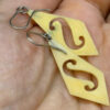 Vintage carved bone dangle earrings in a diamond shape.