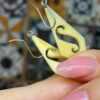 Vintage carved bone dangle earrings in a diamond shape.
