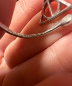 A symbolic ring made of 925 sterling silver, adjustable size, approximate size L