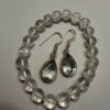 Earrings with large cubic zirconia stones and a natural rock crystal bracelet