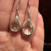 Earrings with large cubic zirconia stones and a natural rock crystal bracelet