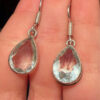 Earrings with large cubic zirconia stones and a natural rock crystal bracelet
