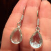 Earrings with large cubic zirconia stones and a natural rock crystal bracelet
