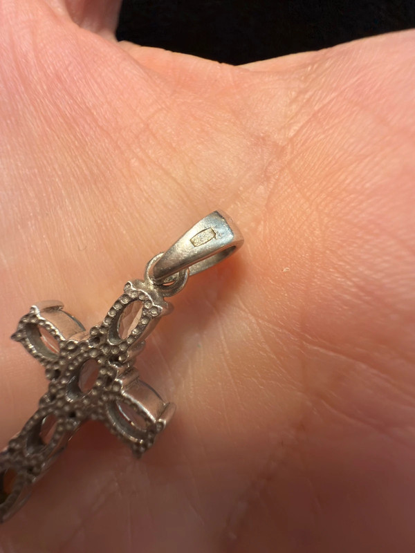Oval cut natural Swiss blue topaz cross pendant in sterling silver