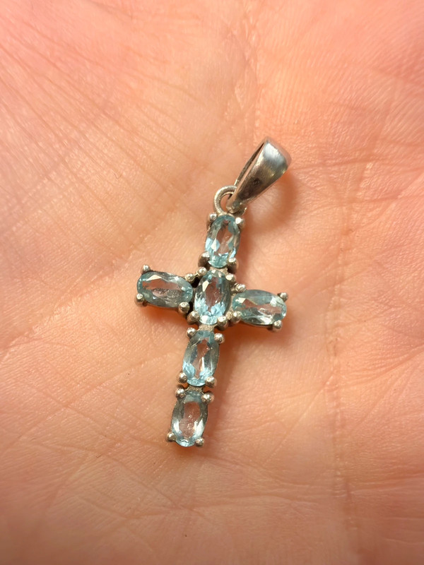 Oval cut natural Swiss blue topaz cross pendant in sterling silver