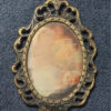 Vintage bronze decorative photo frame with silkscreened print.