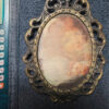 Vintage bronze decorative photo frame with silkscreened print.