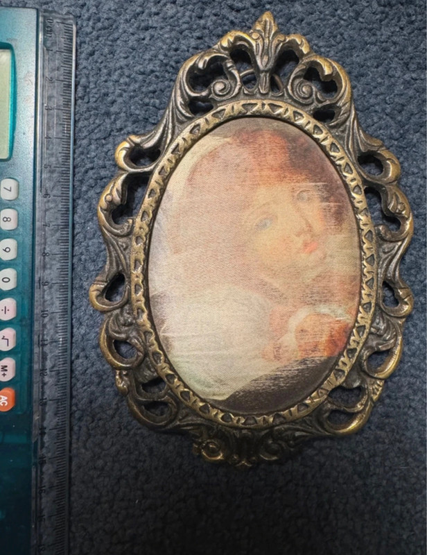 Vintage bronze decorative photo frame with silkscreened print.
