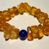 Ancient high-quality large amber bracelet with a chalcedony bead