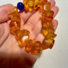 Ancient high-quality large amber bracelet with a chalcedony bead