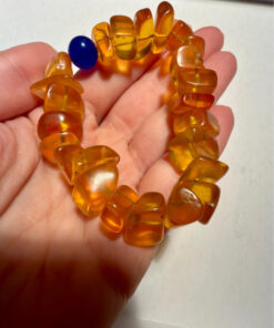 Ancient high-quality large amber bracelet with a chalcedony bead