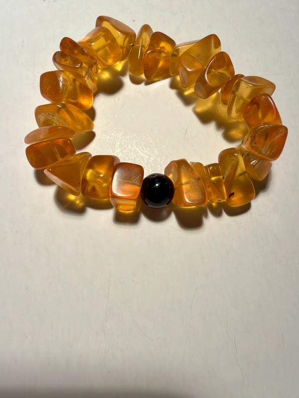 Ancient high-quality large amber bracelet with an onyx bead (for a slender wrist)