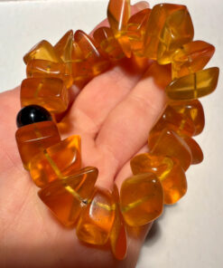 Ancient high-quality large amber bracelet with an onyx bead (for a slender wrist)