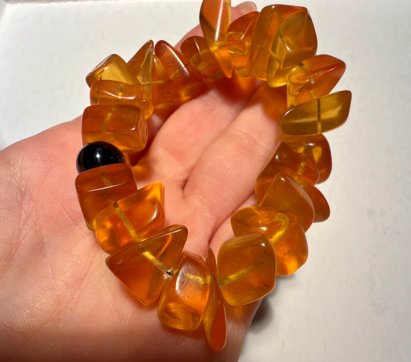Ancient high-quality large amber bracelet with an onyx bead (for a slender wrist)