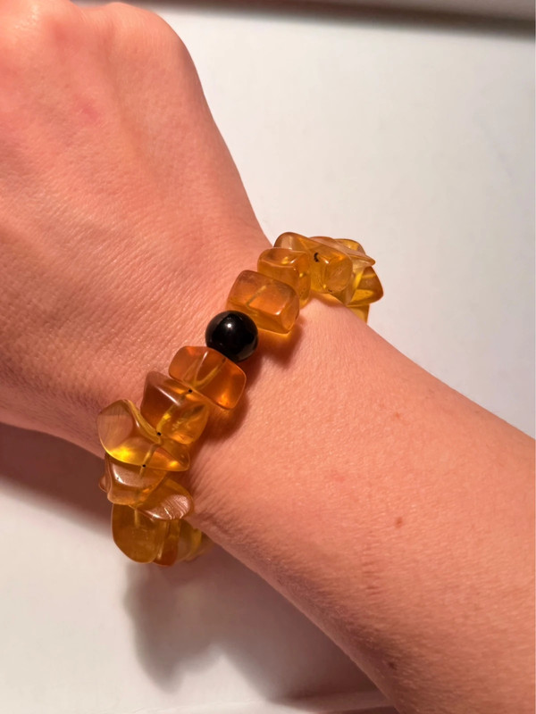 Ancient high-quality large amber bracelet with an onyx bead (for a slender wrist)