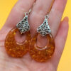 A pair of ornate sterling silver and reconstituted amber earrings #151