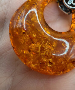 A pair of ornate sterling silver and reconstituted amber earrings