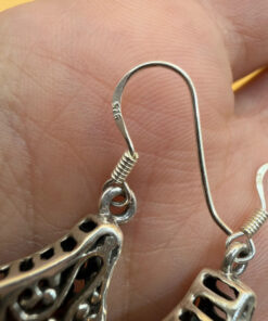 A pair of ornate sterling silver and reconstituted amber earrings