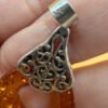 A pair of ornate sterling silver and reconstituted amber earrings #151