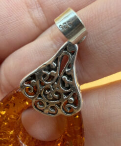 A pair of ornate sterling silver and reconstituted amber earrings