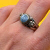 silver ring with a moonstone, adorned with floral patterns. Size R#14
