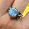 silver ring with a moonstone, adorned with floral patterns. Size R#14