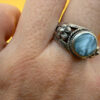 silver ring with a moonstone, adorned with floral patterns. Size R#14