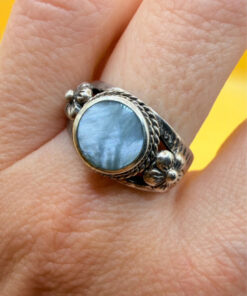 silver ring with a moonstone, adorned with floral patterns. Size R#14