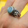 silver ring with a moonstone, adorned with floral patterns. Size R#14