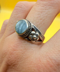 silver ring with a moonstone, adorned with floral patterns. Size R