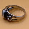 silver ring with a moonstone, adorned with floral patterns. Size R#14
