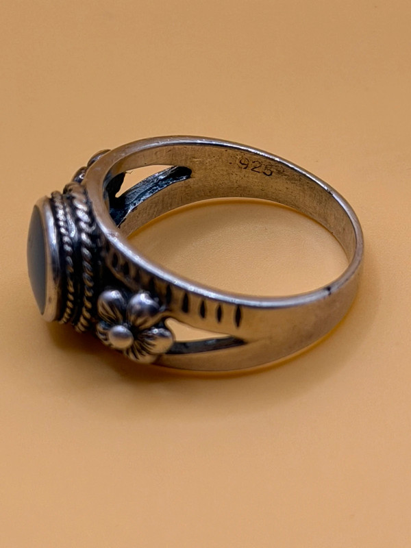 silver ring with a moonstone, adorned with floral patterns. Size R#14