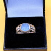 silver ring with a moonstone, adorned with floral patterns. Size R#14