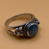 silver ring with a moonstone, adorned with floral patterns. Size R#14