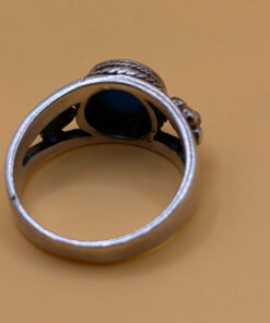 silver ring with a moonstone, adorned with floral patterns. Size R