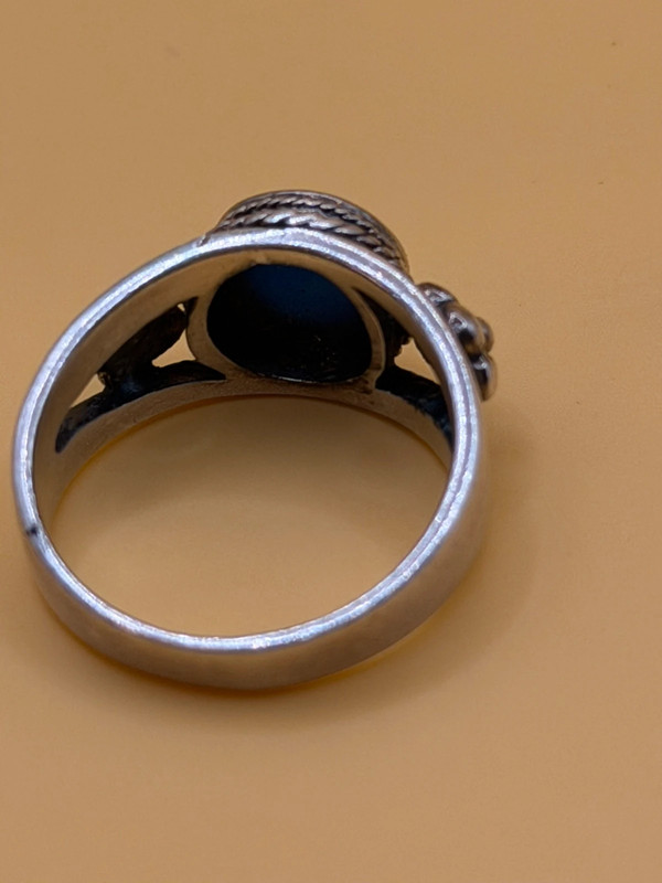 silver ring with a moonstone, adorned with floral patterns. Size R#14