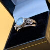 silver ring with a moonstone, adorned with floral patterns. Size R#14