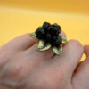 Size L, adjustable ring with black beads.