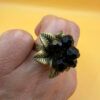 Size L, adjustable ring with black beads.