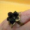 Size L, adjustable ring with black beads.