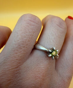 A silver ring with a natural peridot, size N