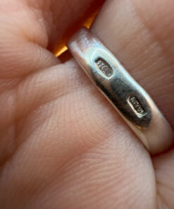 A silver ring with a natural peridot, size N